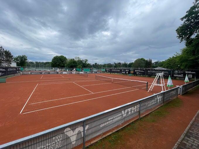 A crowd of spectators watching a tennis match