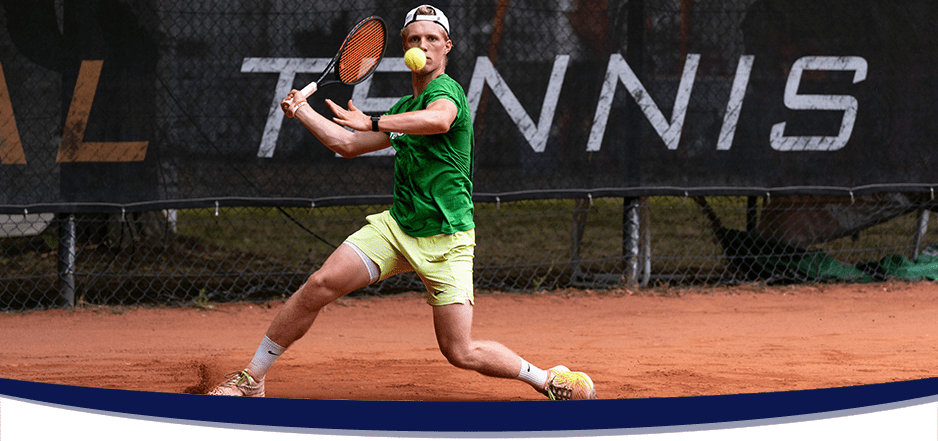 male tennisplayer hitting a backhand