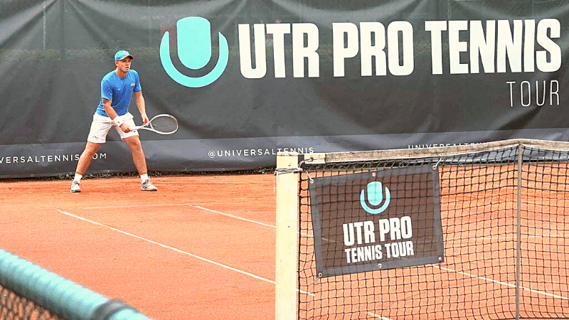 Male tennis player with a blue shirt is ready to retour a serve from the deuce court